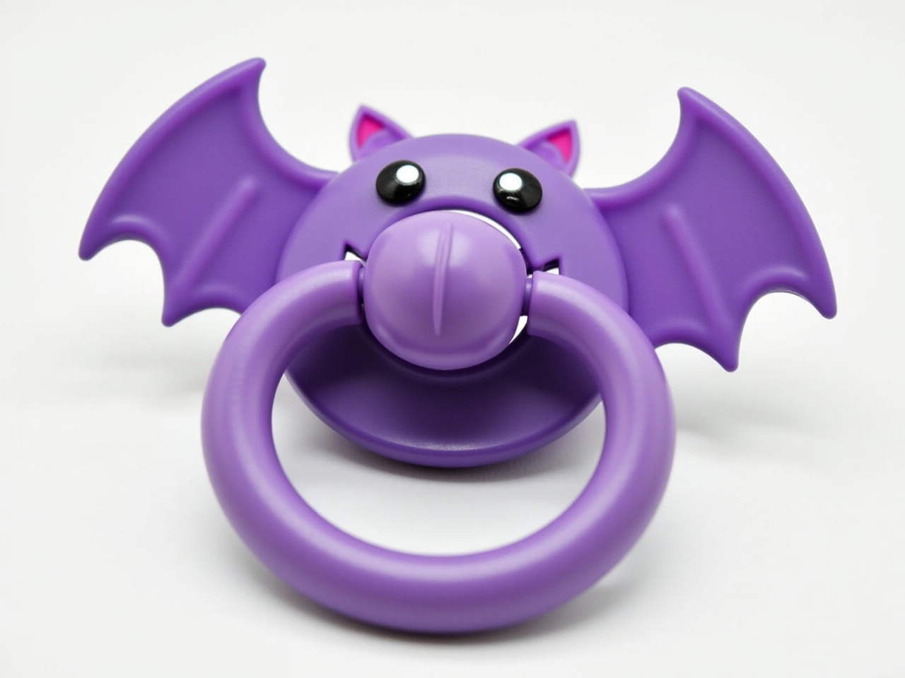 Create a purple pacifier designed with a color scheme reminiscent of a bat. The pacifier should feature the same shades of purple and contrasting accents, resembling the bat character's colors. In the center, integrate bat-like wings that extend outward, mimicking the shape of bat wings. The pacifier's handle should be curvy and integrate seamlessly into the bat design. Ensure that the overall look remains playful and suitable for a child, while creatively interpreting the bat theme.