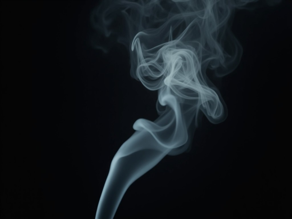 A close-up photograph of wispy smoke swirls against a dark background.