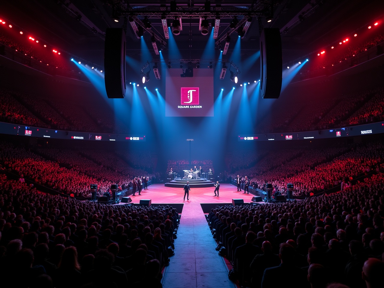 The image captures a vibrant scene during a concert at Madison Square Garden featuring Roddy Ricch. The stage is set with a T-shaped runway extending into the audience. A variety of bright lights illuminate the stage and the performers in the spotlight. The massive crowd fills the arena, creating an energetic atmosphere. This aerial perspective emphasizes the scale of the event and the excitement among attendees.