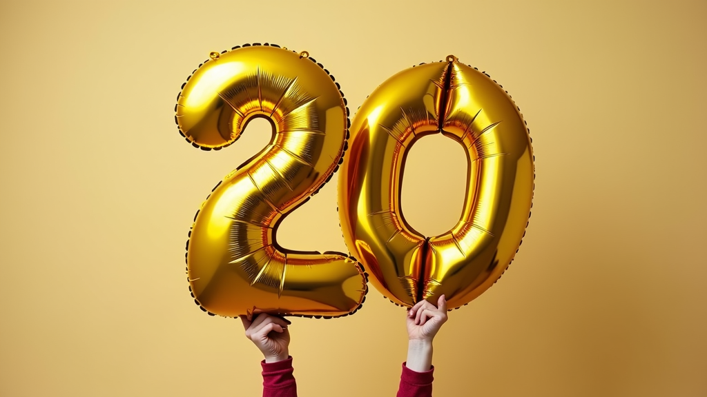 A pair of hands holding up shiny gold foil balloons shaped like the number 20 against a solid yellow background.