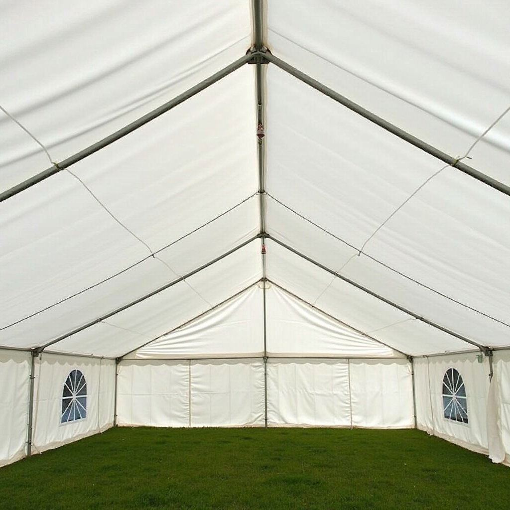 Interior view of a 120x60 tent with a white ceiling drape and green grass floor.