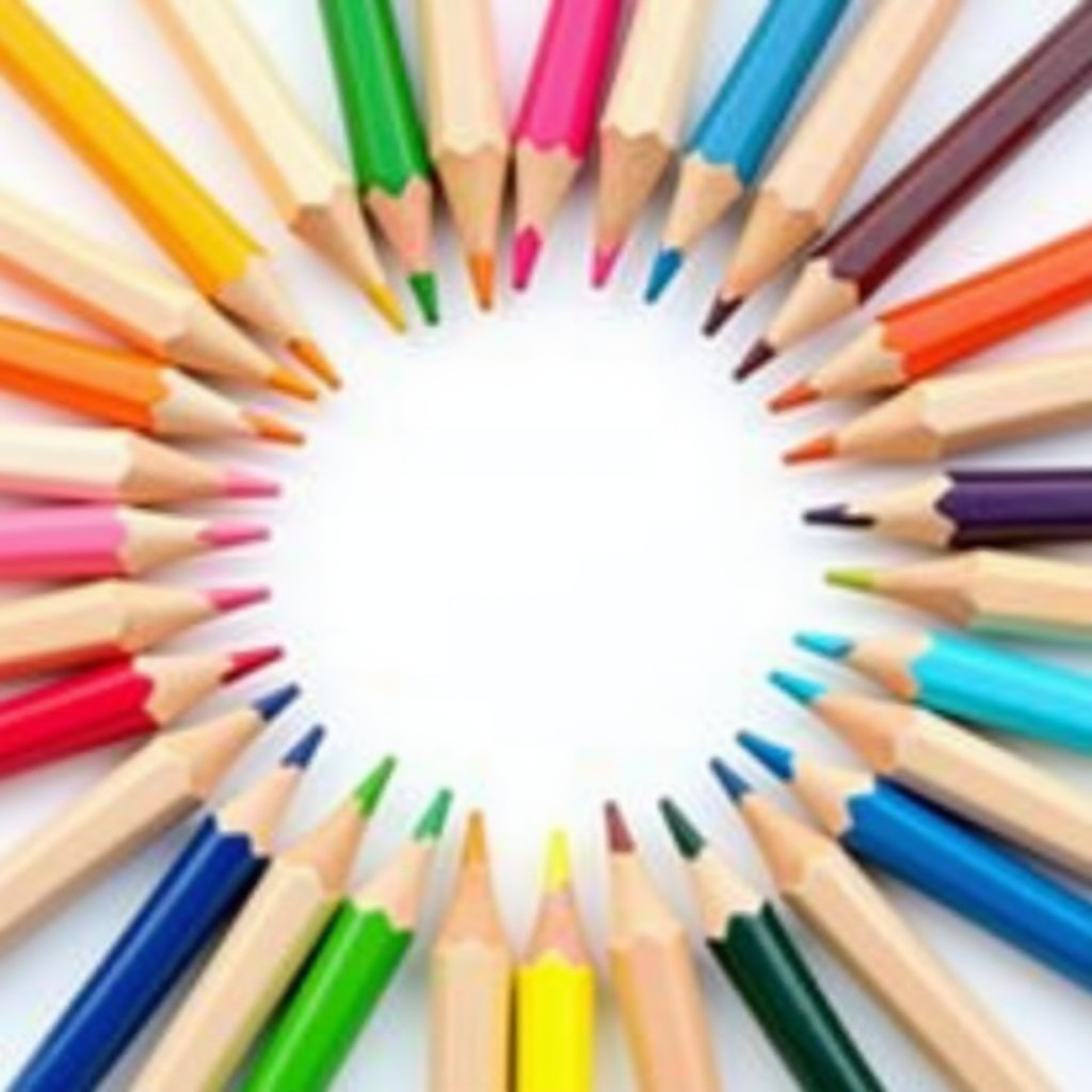 A circular arrangement of colored pencils pointing inward, forming a vibrant, symmetrical pattern with a white center.