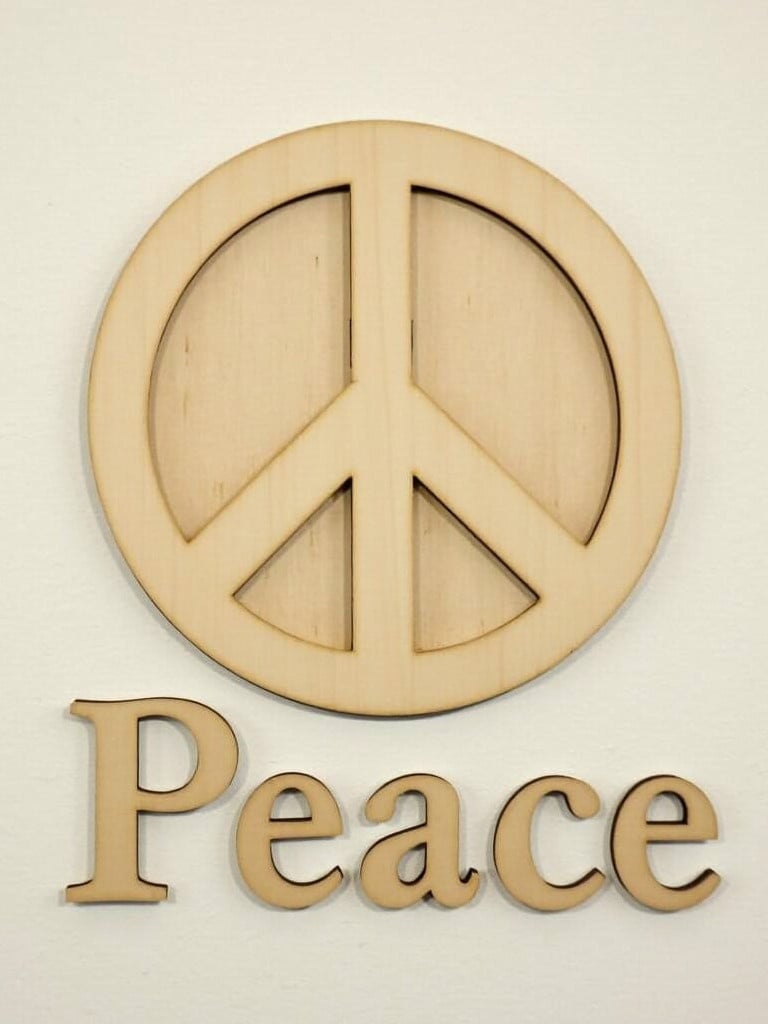 Plywood peace symbol with the word Peace underneath. Dimension range from 6cm to 14cm.