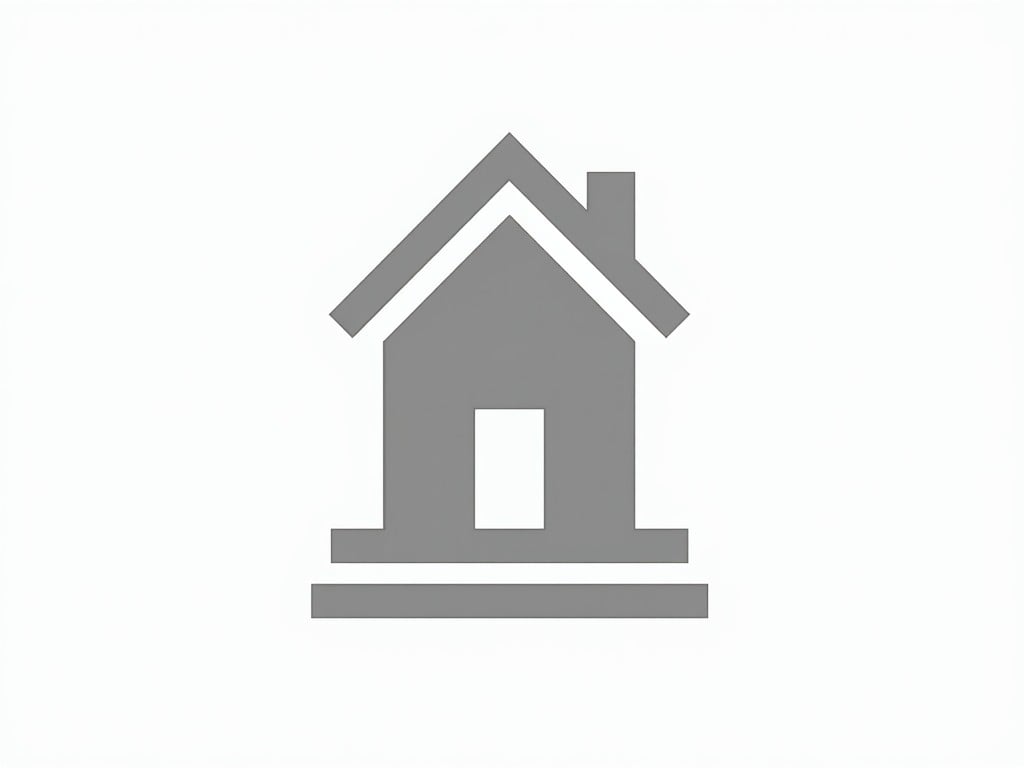 The image depicts a minimalist house icon in a gray color. It is designed with a simplistic and clean aesthetic. The shape of the house features a recognizable roof and a door. The background is a solid white, enhancing the icon's visibility. This stylized representation is suitable for various applications including real estate and design projects.