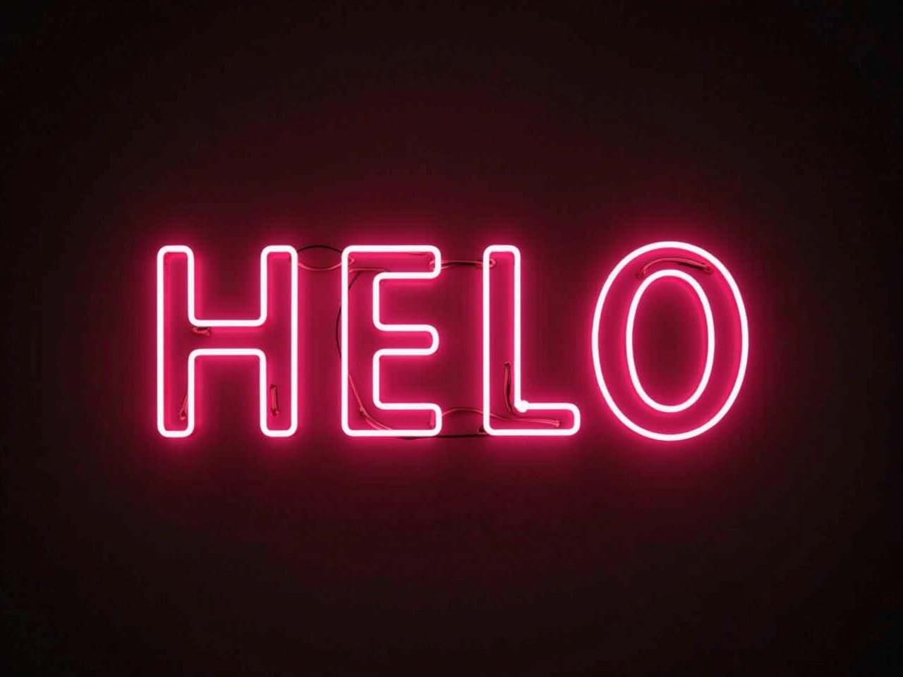 This image features a vibrant neon sign that spells out the word 'HELO'. The letters are bright pink and have a retro style, giving off a warm and inviting glow. The backdrop is dark, which accentuates the brightness of the neon. This signage can be used for various decorative purposes, whether in cafes, homes, or at events. It conveys a fun and casual vibe, making it perfect for attracting attention.