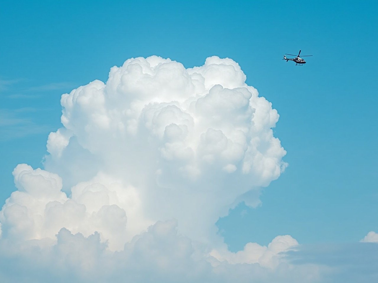 A helicopter is gently flying in a bright blue sky filled with fluffy white clouds. The scene captures the beauty and vastness of nature, highlighting the contrast between the man-made aircraft and the natural cloud formations. The sunlight illuminates the helicopter, making it stand out against the serene background. This image evokes feelings of adventure and exploration. It’s a perfect representation of freedom in the skies and the wonders of aerial views.