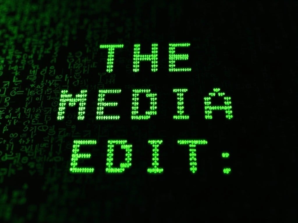 This image features a black screen filled with green programming code, prominently displaying the text 'THE MEDIA EDIT:'. The green text has a glowing effect, creating a striking contrast with the dark background. The overall design evokes a technological atmosphere, reminiscent of coding environments or digital media platforms. It suggests themes of modern editing and media commentary. Ideal for use in articles or content related to technology, media analysis, and digital culture.