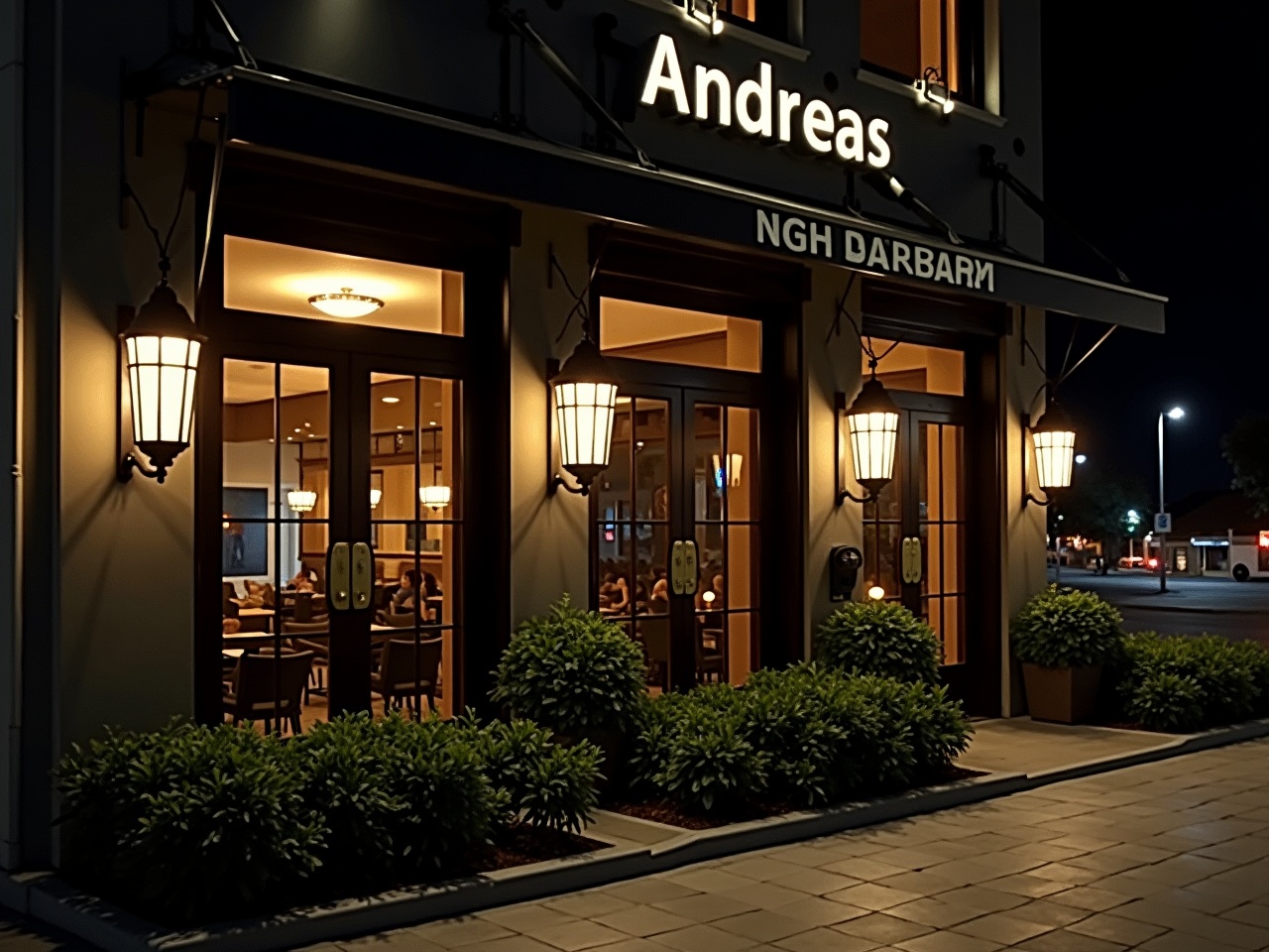 The image depicts the exterior of a restaurant named "Andreas" at night. The building features modern architectural elements with a dark facade and illuminated signage. Large windows reveal a glimpse of the interior, which is warmly lit. Decorative lanterns flank the entrance, adding to the inviting atmosphere. The entrance has an ornate door with gold accents. Surrounding the building are neatly trimmed bushes and small plants that enhance the overall aesthetic of the space.